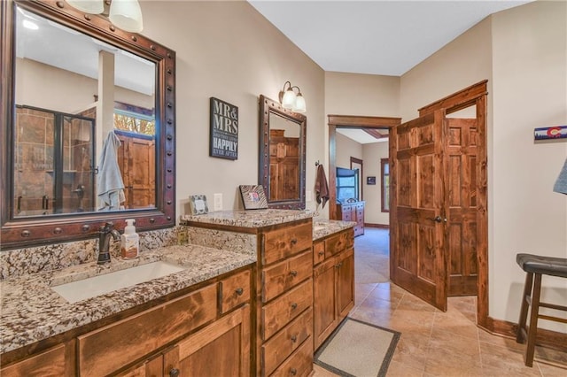 full bathroom featuring baseboards, walk in shower, tile patterned flooring, and vanity
