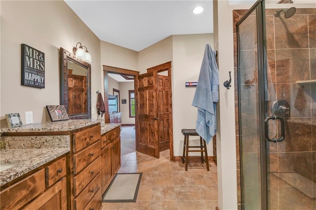 bathroom featuring a shower stall and vanity