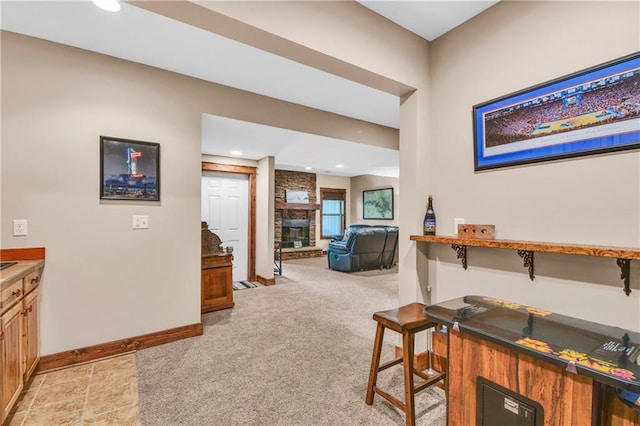 hall featuring baseboards, recessed lighting, and light colored carpet