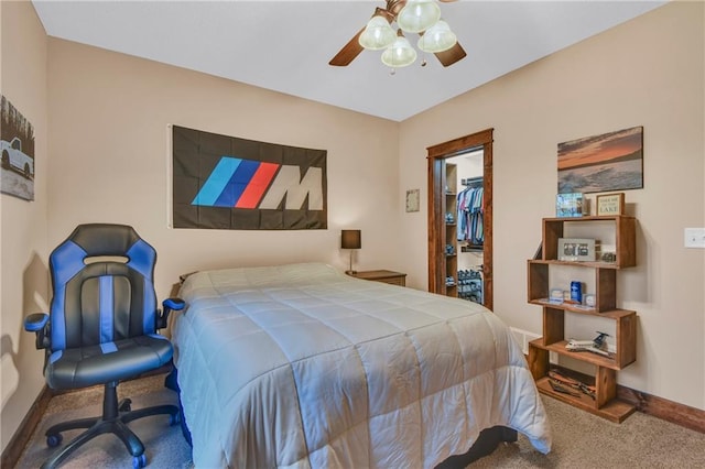 bedroom with a walk in closet, ceiling fan, carpet floors, baseboards, and a closet