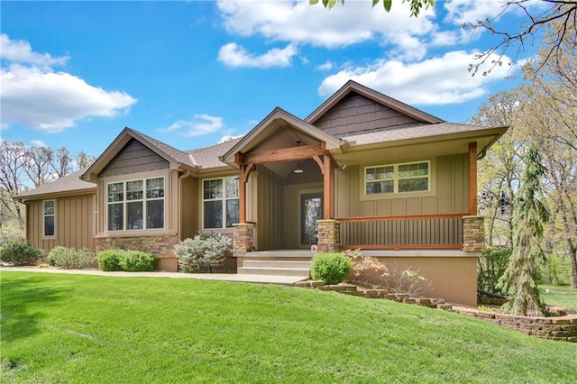 craftsman house with board and batten siding and a front lawn