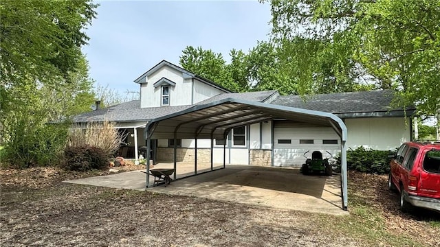 21709 S State Route 7th Hwy, Pleasant Hill, MO 64080 - view of front of property with a garage, dirt driveway, a shingled roof, and a carport