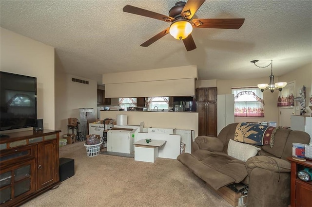 living room featuring a textured ceiling, visible vents, light carpet, and ceiling fan with notable chandelier