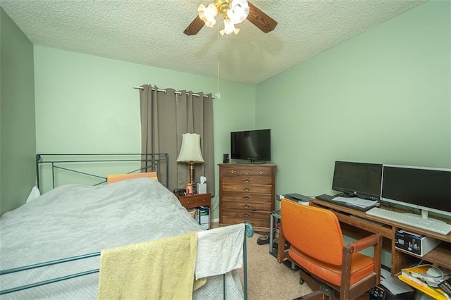 carpeted bedroom with a ceiling fan and a textured ceiling