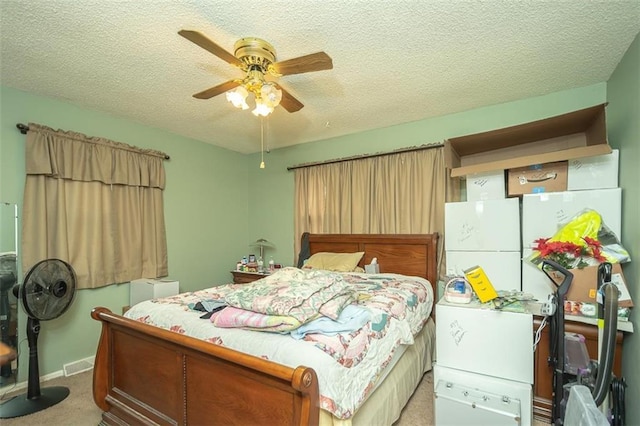 carpeted bedroom featuring baseboards, a ceiling fan, a textured ceiling, and visible vents