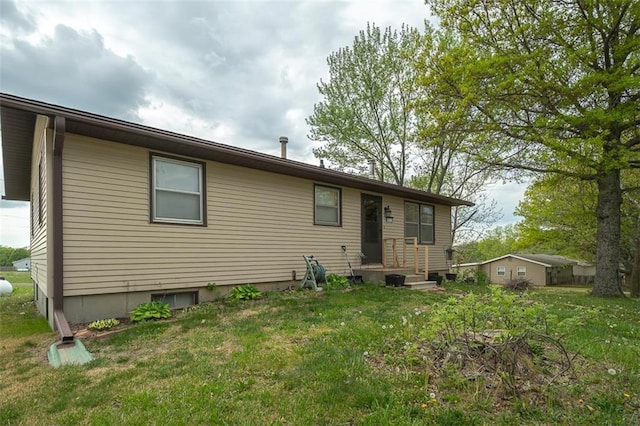 back of property featuring a lawn