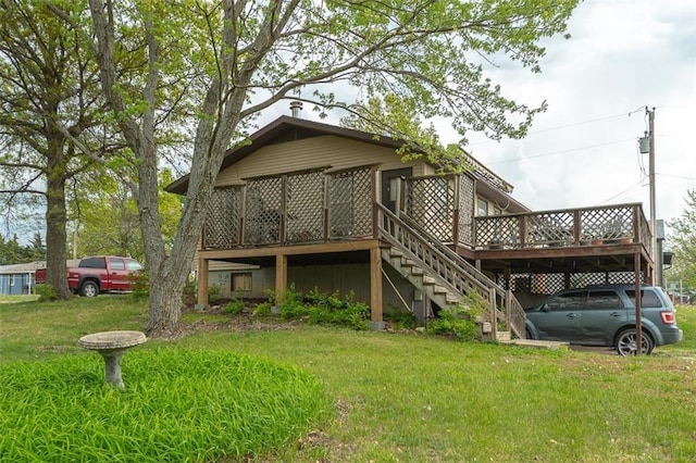 back of house with stairway, a lawn, and a wooden deck