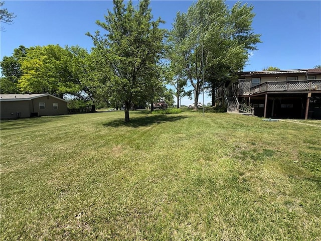 8833 Hickory Ln, Ozawkie, KS 66070 - view of green lawn featuring a wooden deck and stairs