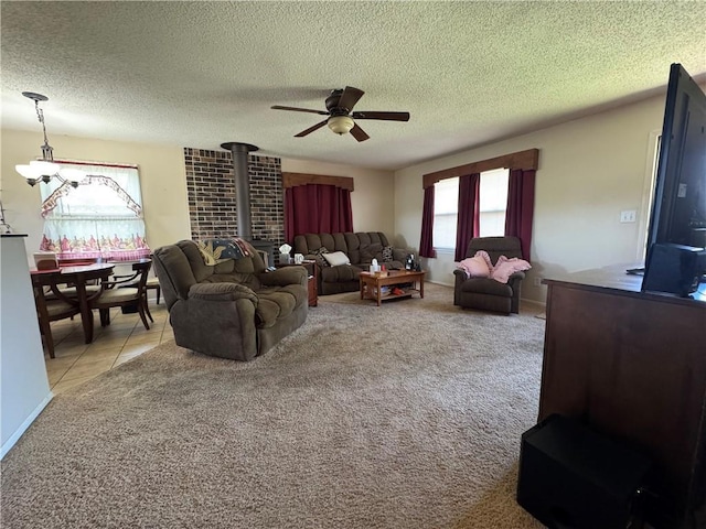 8833 Hickory Ln, Ozawkie, KS 66070 - living room with a wood stove, a ceiling fan, a textured ceiling, and light colored carpet