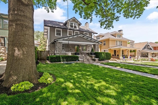12 E 57th St, Kansas City, MO 64113 - traditional style home with a porch, stone siding, and a chimney
