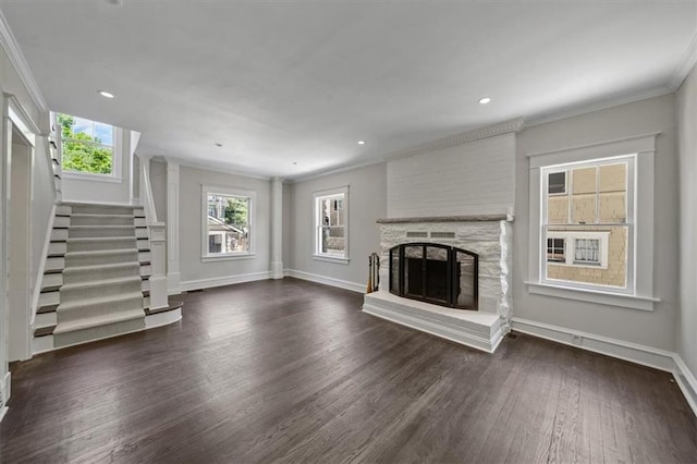 12 E 57th St, Kansas City, MO 64113 - unfurnished living room featuring wood finished floors, crown molding, stairway, baseboards, and a fireplace with raised hearth