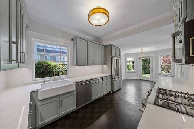 12 E 57th St, Kansas City, MO 64113 - kitchen featuring stainless steel appliances, a sink, gray cabinetry, ornamental molding, and pendant lighting
