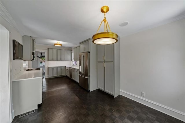12 E 57th St, Kansas City, MO 64113 - kitchen featuring appliances with stainless steel finishes, gray cabinets, light countertops, baseboards, and hanging light fixtures