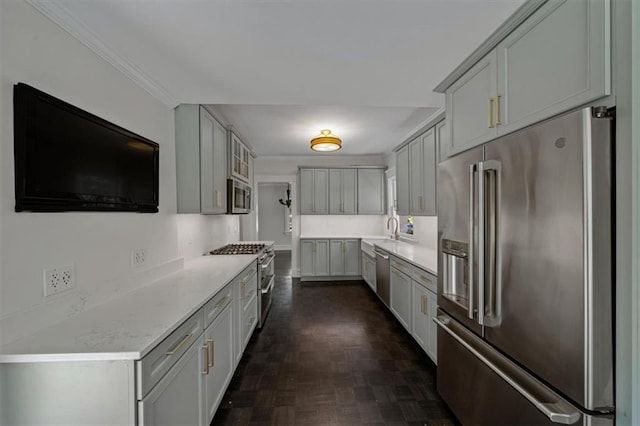 12 E 57th St, Kansas City, MO 64113 - kitchen featuring premium appliances, gray cabinets, light countertops, a sink, and crown molding