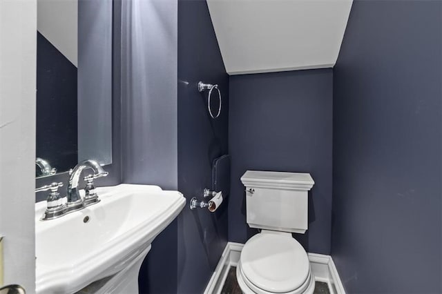 12 E 57th St, Kansas City, MO 64113 - half bath with a sink, baseboards, and toilet
