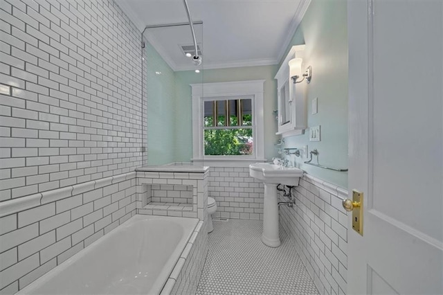 12 E 57th St, Kansas City, MO 64113 - full bathroom featuring tile walls, tile patterned flooring, ornamental molding, a garden tub, and toilet