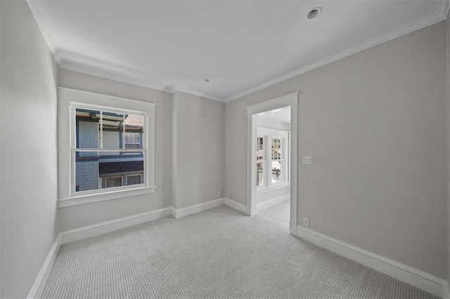 12 E 57th St, Kansas City, MO 64113 - empty room featuring crown molding, light colored carpet, and baseboards