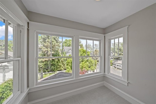 12 E 57th St, Kansas City, MO 64113 - unfurnished sunroom featuring plenty of natural light, carpet flooring, and baseboards
