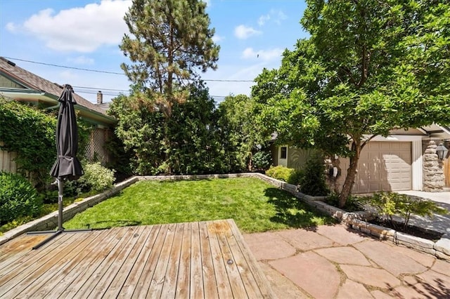 12 E 57th St, Kansas City, MO 64113 - view of green lawn featuring driveway, a garage, and a deck