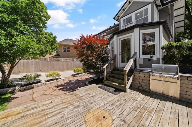 12 E 57th St, Kansas City, MO 64113 - wooden terrace featuring fence, entry steps, area for grilling, and a patio
