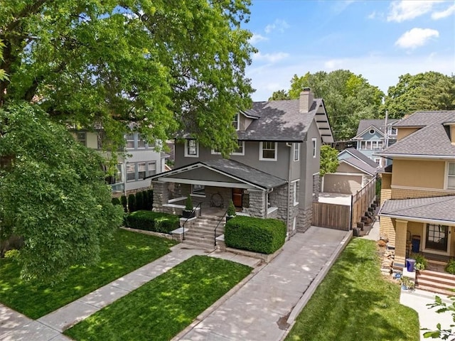 12 E 57th St, Kansas City, MO 64113 - view of front facade featuring stairs, covered porch, and a residential view