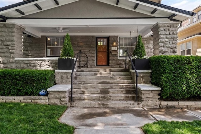 12 E 57th St, Kansas City, MO 64113 - entrance to property with covered porch, stone siding, and ceiling fan