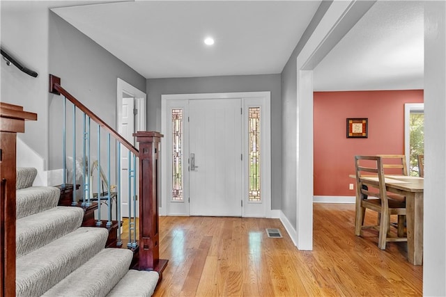 3610 NE Basswood Dr, Lees Summit, MO 64064 - entrance foyer with light wood-style flooring, stairs, and baseboards