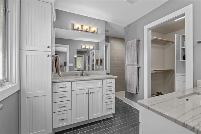 3610 NE Basswood Dr, Lees Summit, MO 64064 - full bath featuring two vanities, a spacious closet, and tiled shower