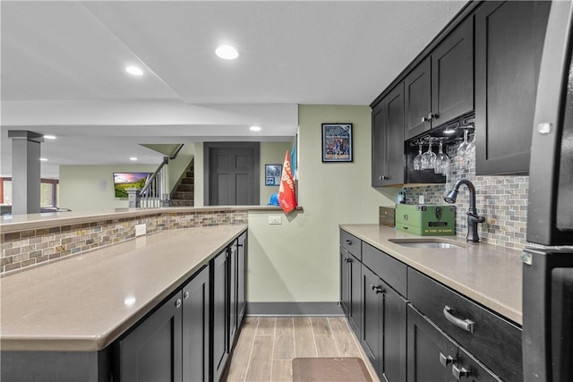 3610 NE Basswood Dr, Lees Summit, MO 64064 - kitchen featuring a sink, baseboards, backsplash, light countertops, and recessed lighting