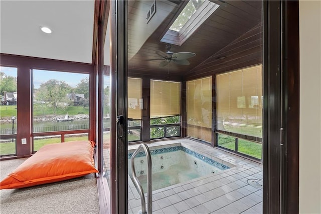 3610 NE Basswood Dr, Lees Summit, MO 64064 - unfurnished sunroom featuring a skylight, a water view, vaulted ceiling, a hot tub, and healthy amount of natural light