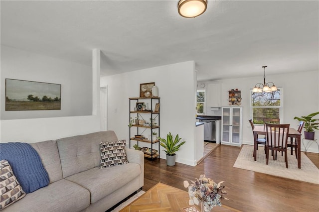 living area featuring an inviting chandelier and wood finished floors
