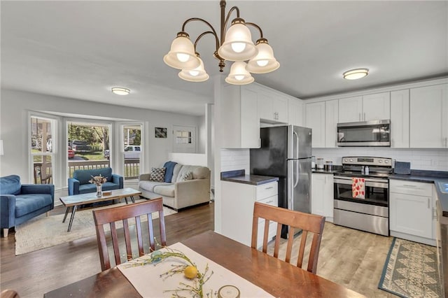 kitchen with dark countertops, stainless steel appliances, and open floor plan