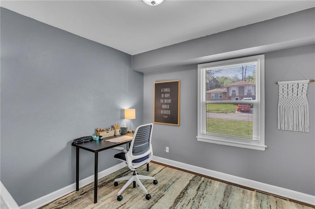 home office featuring baseboards, visible vents, and wood finished floors