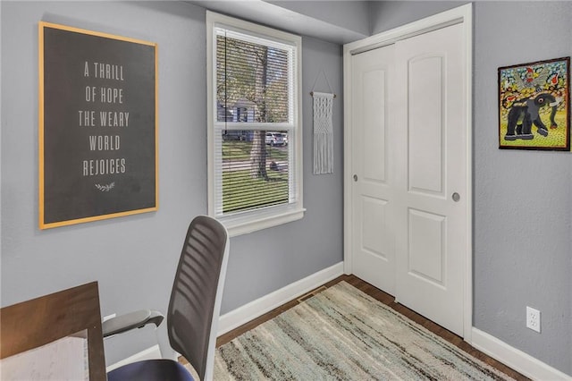 home office featuring baseboards and wood finished floors