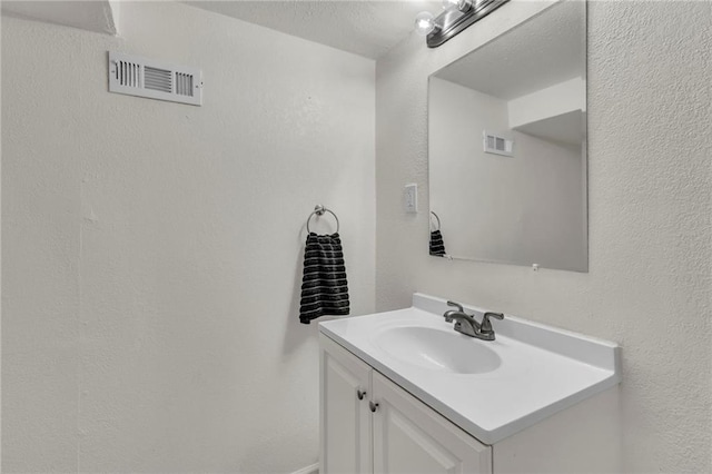 bathroom featuring visible vents and vanity