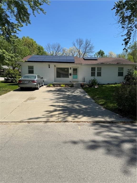 1611 Brookside Dr, Saint Joseph, MO 64506 - ranch-style home with roof mounted solar panels, driveway, and a front yard