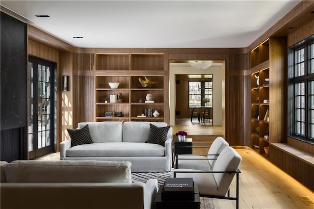 living area with wood finished floors and built in features