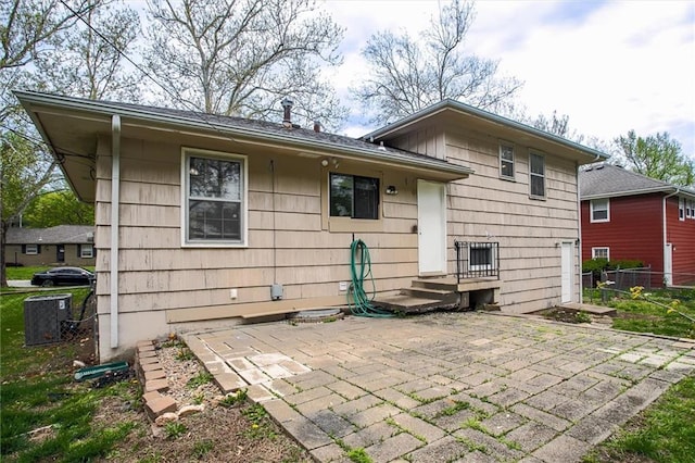 rear view of property with a patio and fence