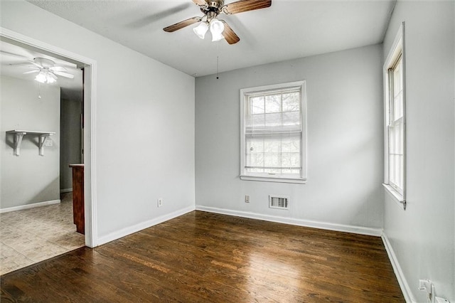 unfurnished bedroom featuring baseboards, visible vents, wood finished floors, and ceiling fan