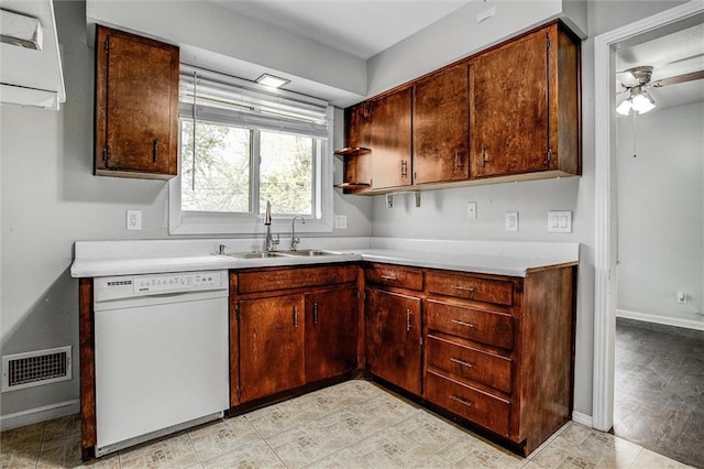kitchen featuring visible vents, light countertops, white dishwasher, and a sink