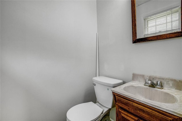 bathroom with toilet and vanity