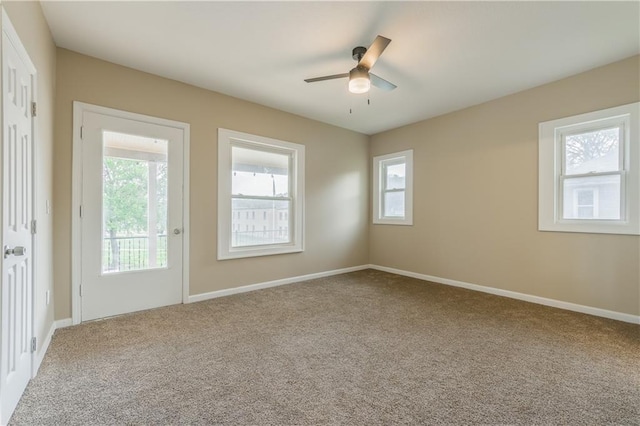 unfurnished room with ceiling fan, baseboards, and carpet floors