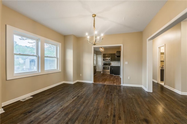 unfurnished dining area with visible vents, a notable chandelier, baseboards, and dark wood-type flooring