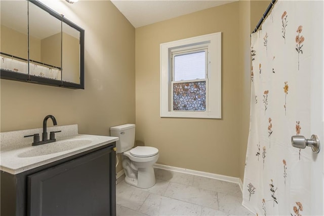 bathroom with vanity, curtained shower, toilet, marble finish floor, and baseboards