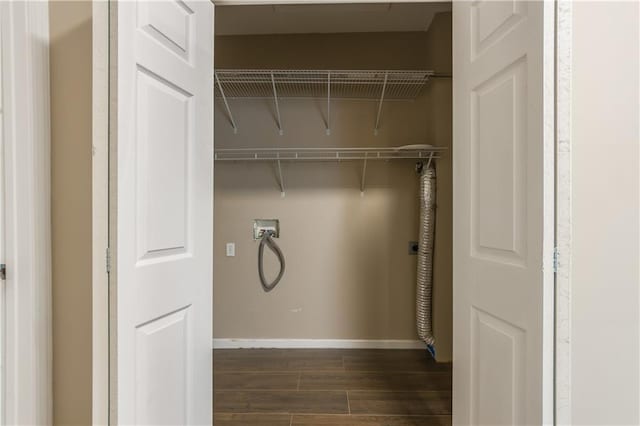washroom featuring hookup for an electric dryer, baseboards, hookup for a washing machine, dark wood-type flooring, and laundry area