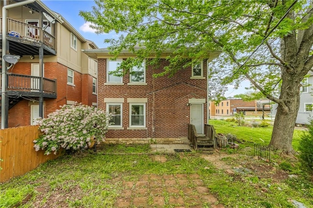 back of house with entry steps and brick siding