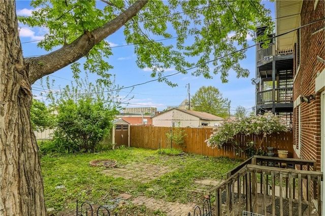 view of yard with an outdoor structure, a shed, and a fenced backyard