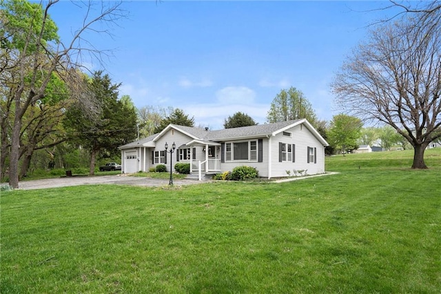 single story home with an attached garage, driveway, and a front lawn