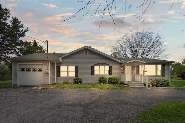 ranch-style home featuring an attached garage and driveway