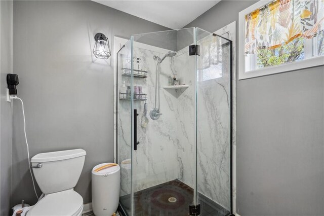 full bathroom with toilet and a marble finish shower